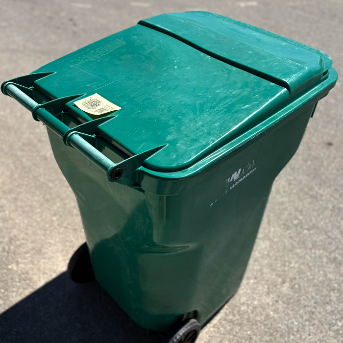 trash bin cleaning service advertisement on bin lid