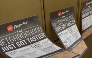Pizza Hut Pizza Flyer Advertising on mailboxes blowing in the wind.