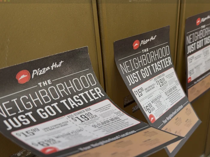 Pizza Hut Pizza Flyer Advertising on mailboxes blowing in the wind.
